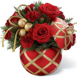 Red roses arranged with gold ornaments in a decorative container