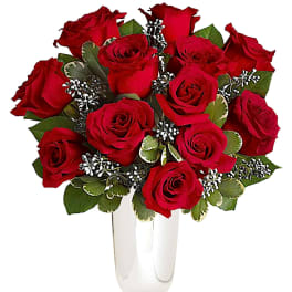 Red roses arranged in a clear glass vase