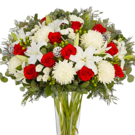 Red roses and white lilies in a clear glass vase