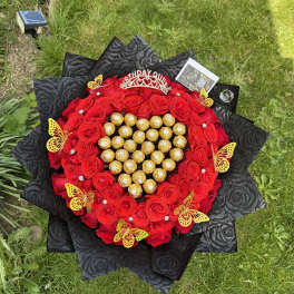 Heart-shaped bouquet of red roses with gold-wrapped chocolates and a birthday topper