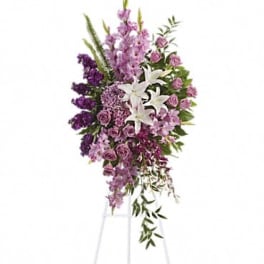 Tall purple and white floral standing spray on an easel