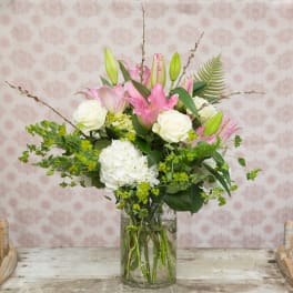 Pink lilies and white roses in a glass vase