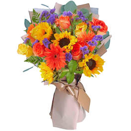 Bouquet of sunflowers, roses, and orange gerbera daisies wrapped in paper