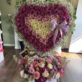 Heart-shaped rose arrangement with a smaller mixed flower bouquet below