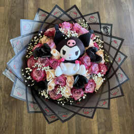 Bouquet of pink and cream roses with a Kuromi plush centerpiece