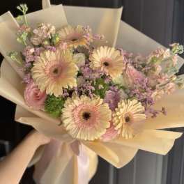 Bouquet of pale pink and cream gerbera daisies with pink roses