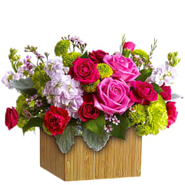 Bright mixed flower arrangement in a square wooden box
