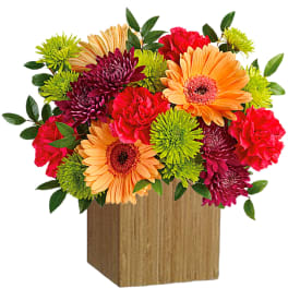 Colorful mixed bouquet in a wooden cube vase