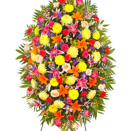 Large standing floral spray with bright mixed flowers on a white background