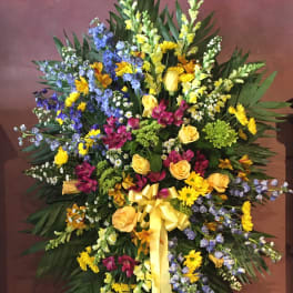 Large mixed floral spray with yellow roses and blue flowers