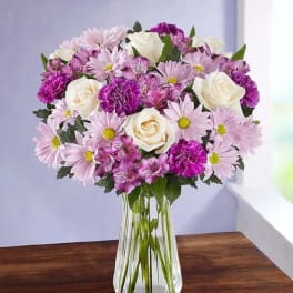 Pink and white mixed bouquet in a clear glass vase