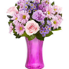 Pink and purple mixed bouquet in a tall ribbed vase