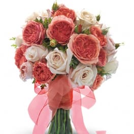 Bouquet of pink and white roses tied with a pink ribbon