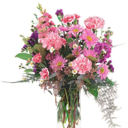 Pink and purple mixed bouquet in a clear glass vase