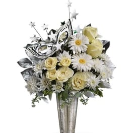 White roses and daisies in a tall silver vase with star picks