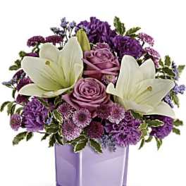 Purple bouquet with white lilies in a lavender vase