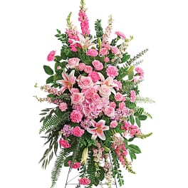 Tall pink floral standing spray on an easel