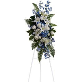 White and blue floral standing spray on a metal easel