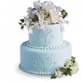 Two-tier blue cake with white floral decorations