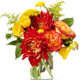 Bouquet of red, orange, and yellow flowers in a clear glass vase