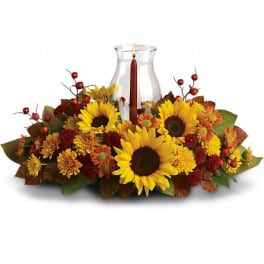 Sunflower and autumn flower centerpiece with a glass candle holder