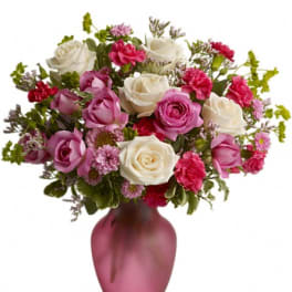 Pink and white rose bouquet in a pink vase