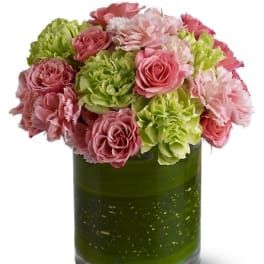 Pink and green flowers arranged in a glass vase