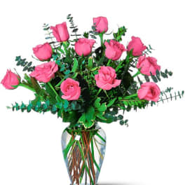 Pink roses arranged in a clear glass vase