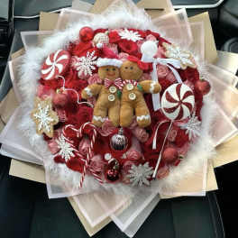 Holiday bouquet with red roses, candy ornaments, and two gingerbread figures