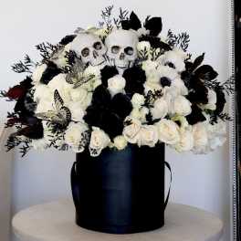 Black floral box with white roses and skull decorations
