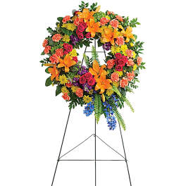 Colorful funeral wreath on a black easel stand