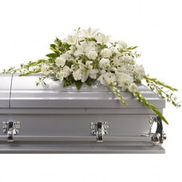 White floral spray on a silver casket
