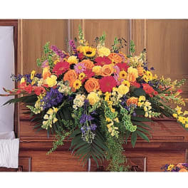 Large colorful floral arrangement on a casket