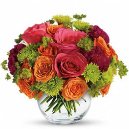 Bouquet of pink and orange roses in a clear glass vase