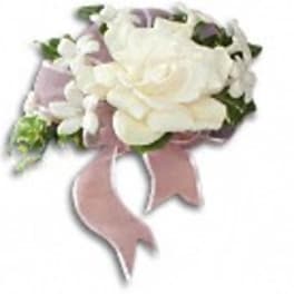 White rose corsage with a pink ribbon