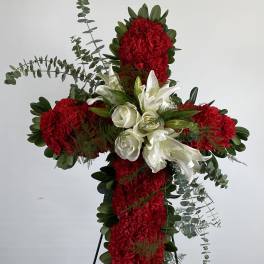 Red and white floral cross on a stand