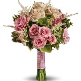 Pink and cream rose bouquet with green accents and a wrapped handle