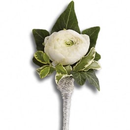 White ranunculus boutonniere with green leaves
