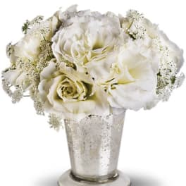 White roses arranged in a silver vase