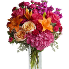 Bouquet of pink and orange flowers in a clear glass vase