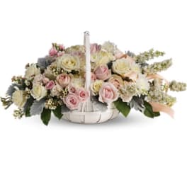Low floral basket with pink and cream roses and white blooms