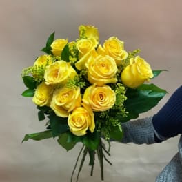 Bouquet of yellow roses with green filler and leaves