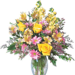 Bouquet of yellow roses and pink daisies in a clear glass vase