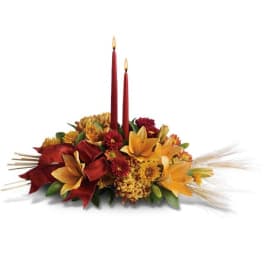 Autumn floral centerpiece with two red taper candles