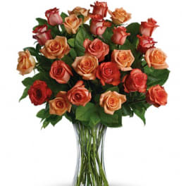 Bouquet of orange and red roses in a clear glass vase