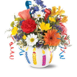 Colorful mixed bouquet in a white vase decorated with birthday candles