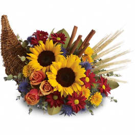 Sunflower bouquet with roses and daisies in a wicker cornucopia