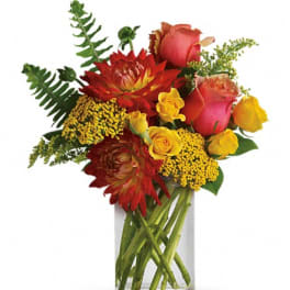 Bouquet of red and yellow flowers in a clear glass vase