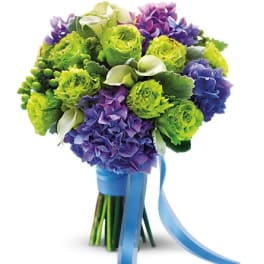 Bouquet of green and purple flowers tied with a blue ribbon