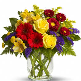 Bouquet of red and yellow flowers in a clear glass vase